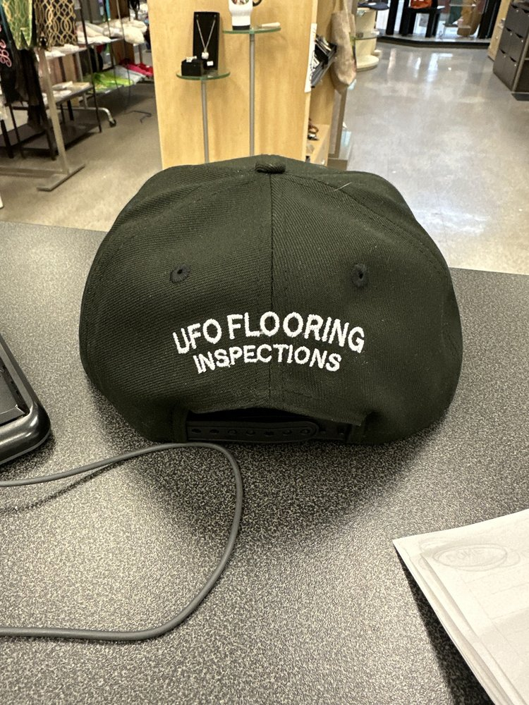 Black cap embroidered with 'UFO Flooring Inspections'